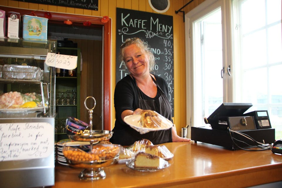 HJEMMEBAKT MED ET SMIL: Birgitte Rommen lager all mat fra bunnen på Kafé Steinbra. Bydelens budsjett kan bety at det blir slutt på fersk bakst fra neste sommer av. Foto: