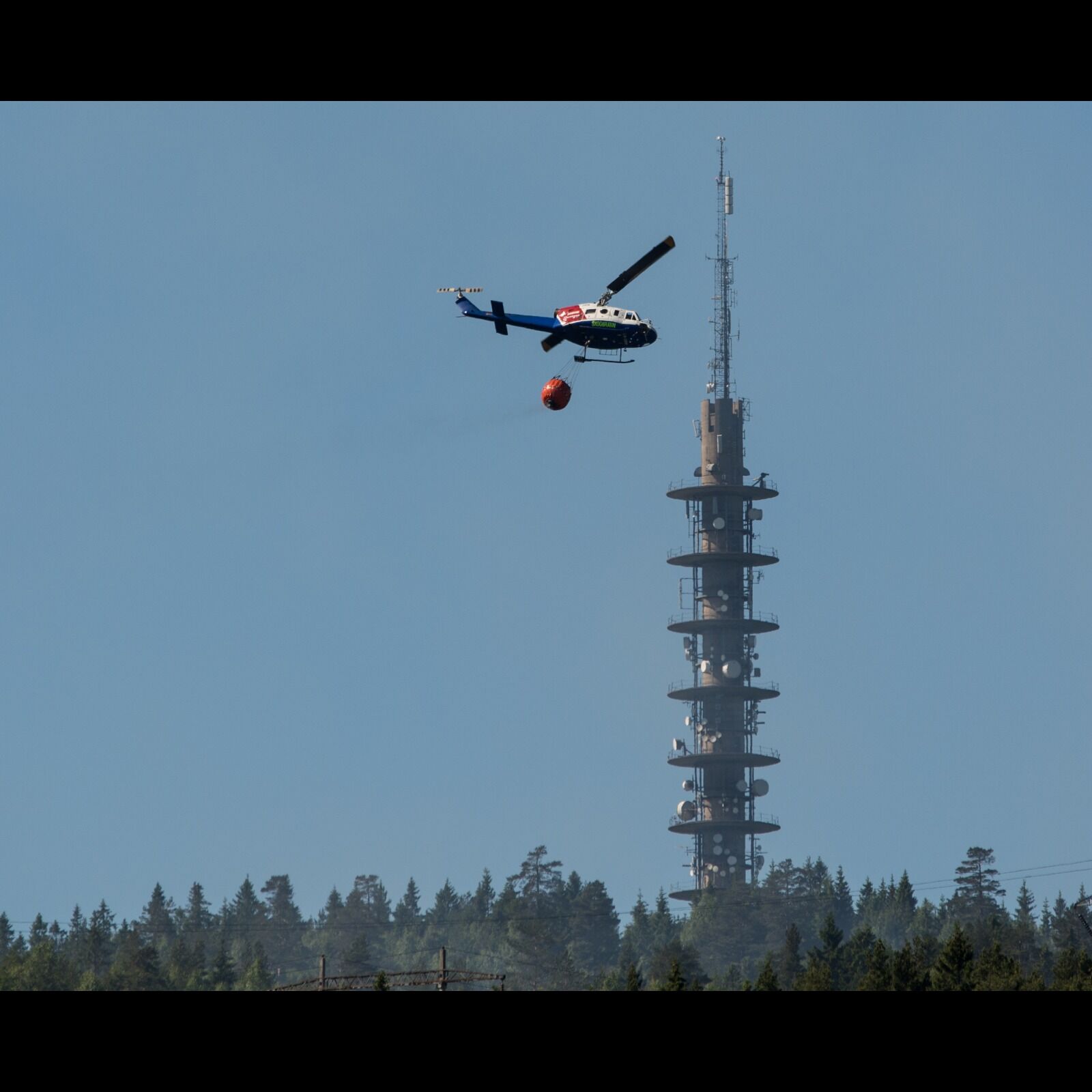 HELIKOPTER: Det virker som brannvesenet begynner å få kontroll over brannen på Romsås nå.  Trond Gjerde har tatt dette bildet fra verandaen sin på Vestli. Foto: