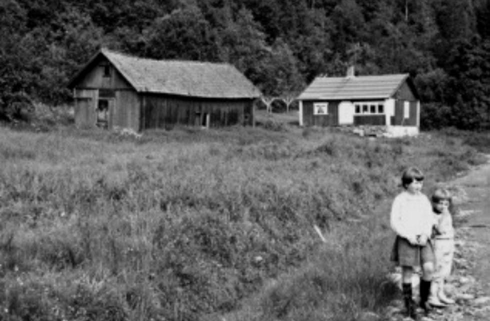 Bildet viser våningshuset på Enga med innebygget glassveranda og den gamle låven. Bildet er tatt i 1962-1963. Foto: Gunnar Søderstrøm.