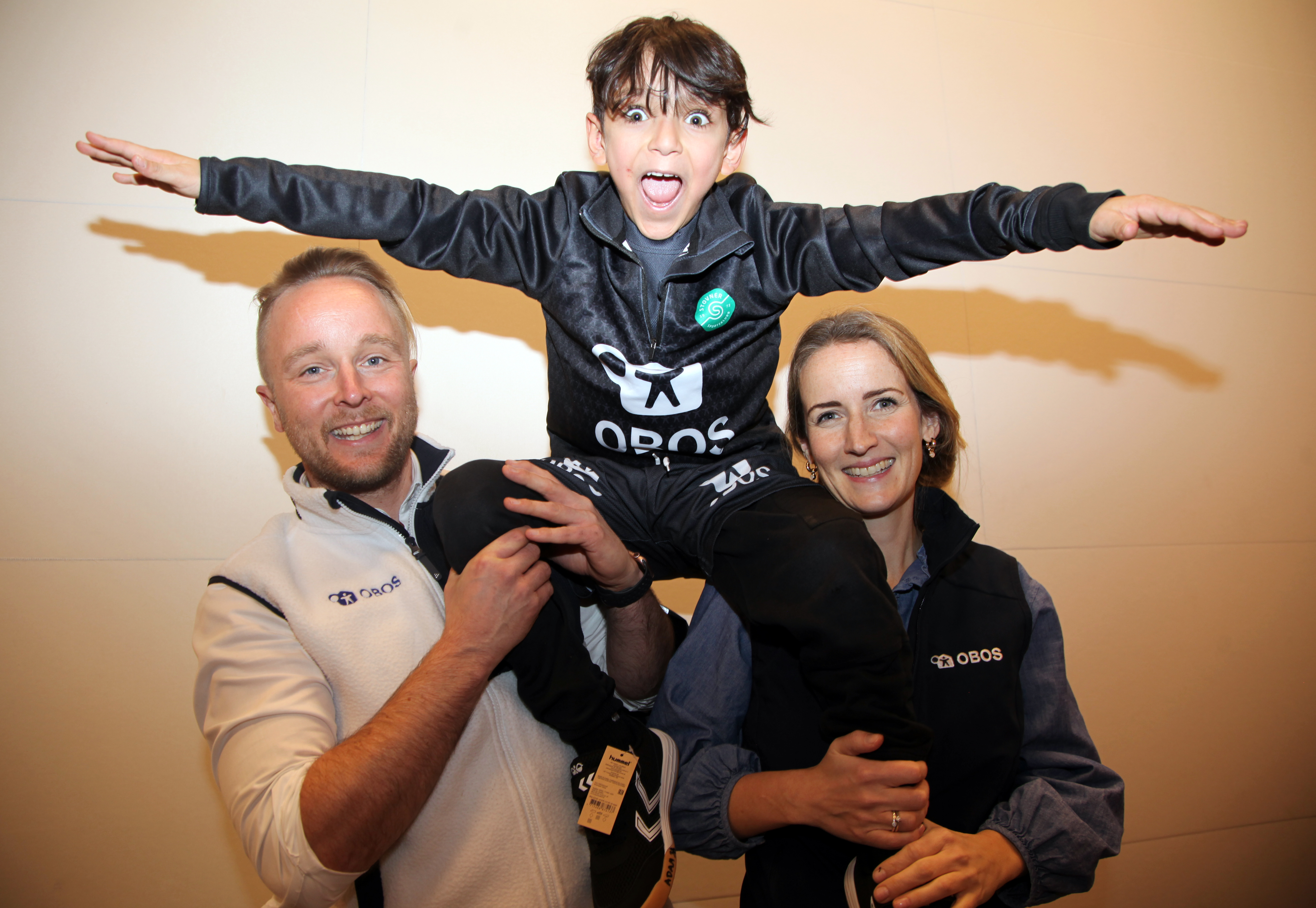 Tredjeklassingen Adam var i ekstase etter å ha tatt på seg de ny klærne sine. Her med Erlend Wessel Carlsen og Ingjerd Sælid Gilhus fra OBOS. Foto: Rolf E Wulff.